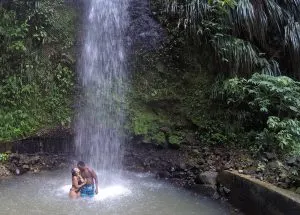honeymooners at a waterfall in st lucia