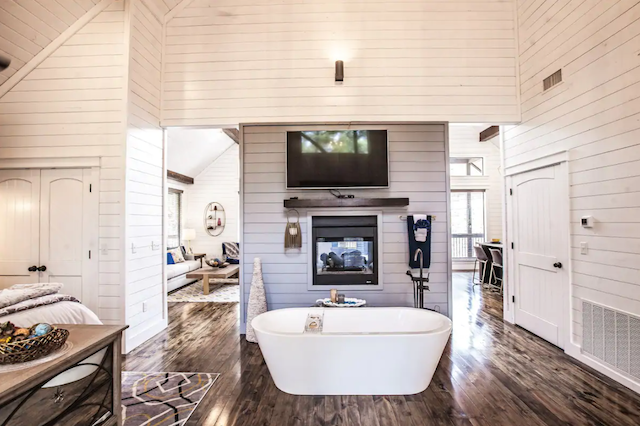 luxury cabin bath tub next to fireplace