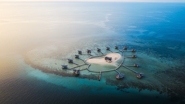 The heard shaped island surrounded by overwater bungalows in Indonesia