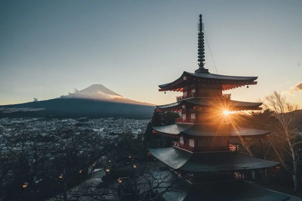 A Japanese building with a large mountain in the background.
