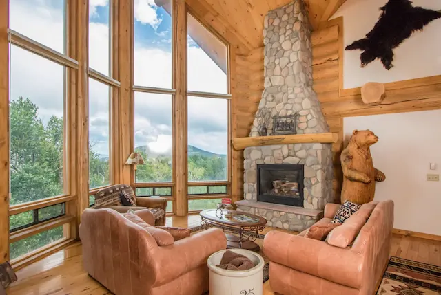 Cabin living room with large windows and a view