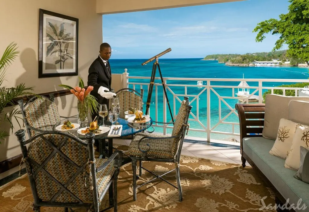 Sandals Royal Plantation Resort - Butler pouring champagne in a room overlooking the sea