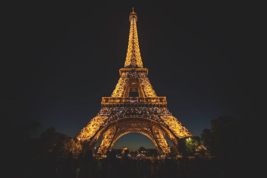 Night view of the Eiffel Tower all lit up.