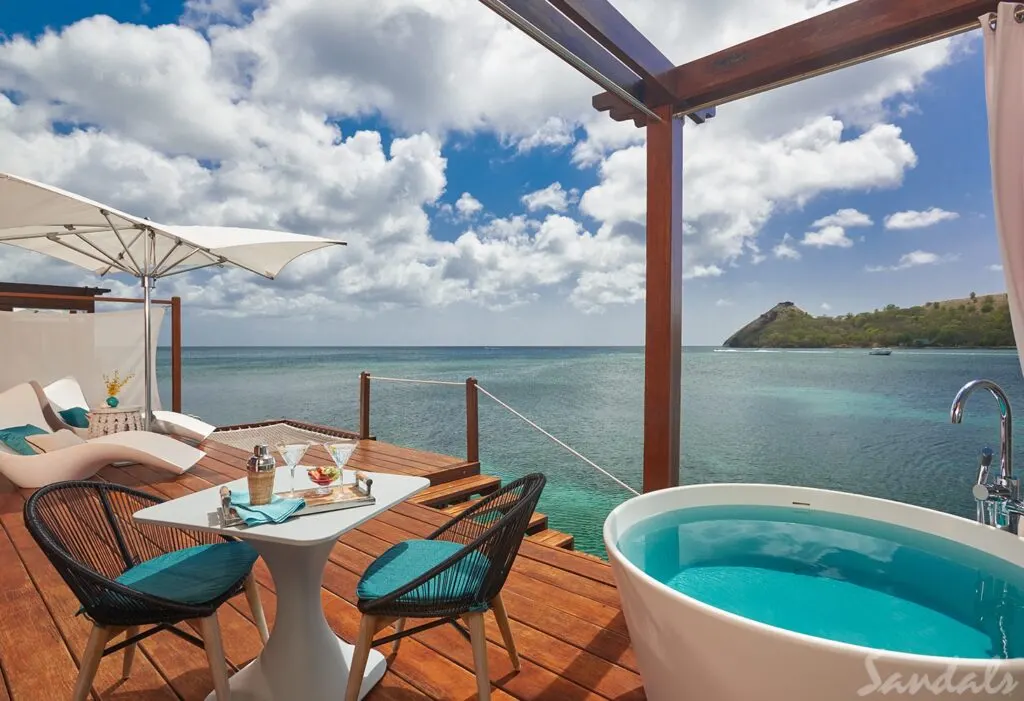 Sandals St Lucia Overwater Bungalow deck with hot tub lounge chairs and small table